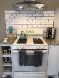 a kitchen with a stove with a tea kettle on it at The Comfi Coral - Large 1 Bedroom Studio A in Baytown