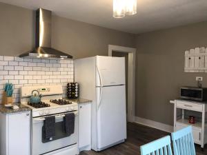 a kitchen with a white refrigerator and a stove at The Comfi Coral - Large 1 Bedroom Studio A in Baytown +12 photos