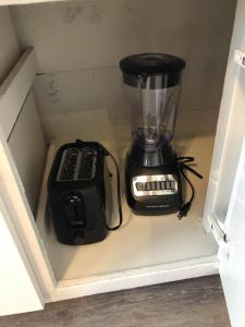 a blender is sitting inside of a drawer at The Comfi Coral - Large 1 Bedroom Studio A in Baytown