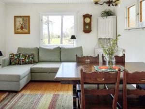 a living room with a couch and a table at 5 person holiday home in Mellösa in Mellösa +35 photos