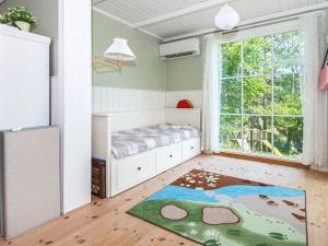 a bedroom with a bed and a large window at 8 person holiday home in Ebeltoft in Ebeltoft