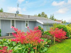 a house with pink flowers in front of it at 6 person holiday home in Sydals in Neder Lysabild