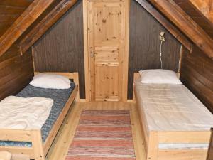 two beds in a room with wooden walls at 4 person holiday home in Måndalen-By Traum in Sæbø