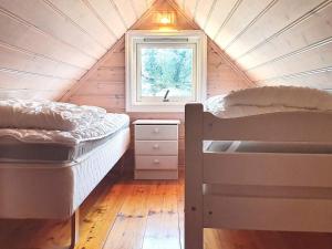 two beds in a tiny house with a window at 9 person holiday home in Utsira-By Traum in Utsira