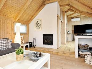 a living room with a couch and a fireplace at 8 person holiday home in Vejers Strand in Vejers Strand