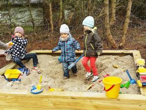a group of children playing in a sandbox at 10 person holiday home in V ggerl se in Marielyst
