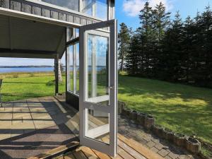 a door to a house with a view of a field at 4 person holiday home in H jslev in Højslev