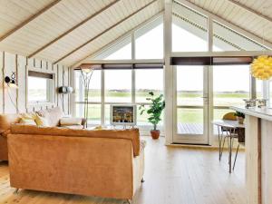 a living room with a couch and a fireplace at 6 person holiday home in Storvorde-By Traum in Egense