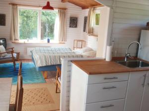 a kitchen with a sink and a bedroom with a bed at Two-Bedroom Holiday home in Dannemare 1 in Dannemare