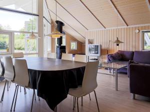 a dining room and living room with a table and chairs at 7 person holiday home in Asn s in Asnæs