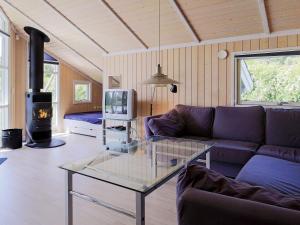 a living room with a couch and a glass table at 7 person holiday home in Asn s in Asnæs