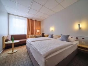 Giường trong phòng chung tại Best Western Hotel Prisma