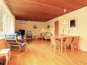a living room with a dining room table and chairs at 4 person holiday home in Dannemare in Dannemare