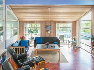 a living room with a couch and a table at 12 person holiday home in Glesborg in Fjellerup Strand