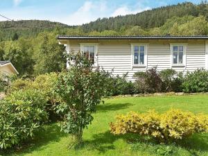 une maison avec un jardin en face dans l'établissement Three-Bedroom Holiday home in Åram 1, à Sandvik