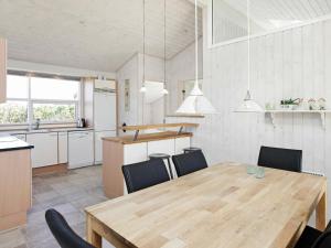 ロンストラップにある9 person holiday home in Hj rringのキッチン、ダイニングルーム(木製のテーブルと椅子付)