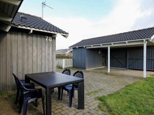 a black table and chairs in a yard at 6 person holiday home in Harbo re in Harboør