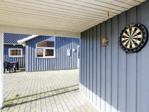 a dart board on the side of a building at 6 person holiday home in Harbo re in Harboør