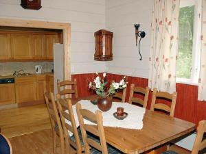 a dining room table with a vase of flowers on it at 8 person holiday home in isfjorden-By Traum in Torvik
