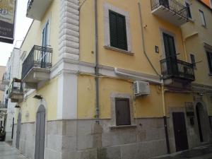 a yellow and white building on the side of a street at B&B Del Corso in Margherita di Savoia
