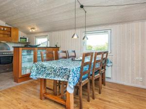 a kitchen with a dining room table and chairs at 6 person holiday home in Hemmet in Falen