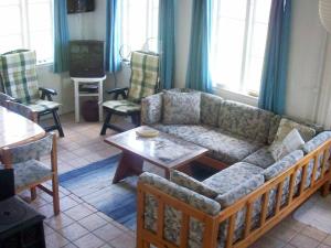 a living room with a couch and a table at 6 person holiday home in Aabenraa in Aabenraa