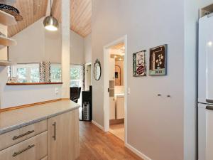 a kitchen with white walls and wooden floors at 6 person holiday home in Hadsund in Odde