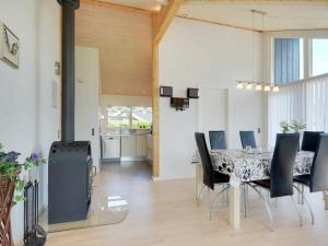 a dining room with a table and chairs at Three-Bedroom Holiday home in Hemmet 52 in Hemmet