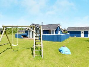 a playground with a ladder and a swing in a yard at Luxury Retreat with Spa - By Traum Ferienwohnungen in Hemmet
