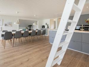 a kitchen and dining room with a table and chairs at 12 person holiday home in Vejers Strand in Vejers Strand