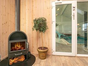 Nørre Lyngby的住宿－16 person holiday home in L kken，旁边一个植物的壁炉