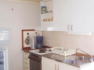 a kitchen with a sink and a stove top oven at 2 person holiday home in LYSEKIL in Lysekil