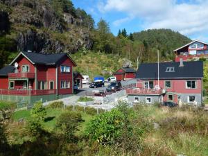 a group of red houses in a mountain at Four-Bedroom Holiday home in Hosteland in Hosteland