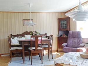 a living room with a dining room table and chairs at 4 person holiday home in BRUA KULLA in Källekulla