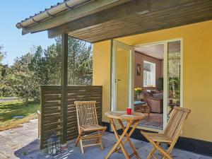 a patio with two chairs and a table on a porch at 6 person holiday home in Aakirkeby in Vester Sømarken