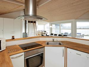 een keuken met een wastafel en een fornuis bij 8 person holiday home in Jerup in Jerup