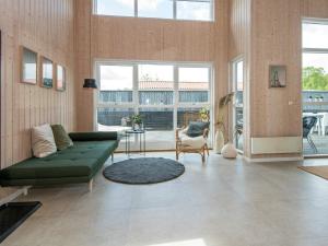 a living room with a green couch and a table at 6 person holiday home in Bjert in Sønder Bjert