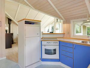 a kitchen with a white refrigerator and a stove at 6 person holiday home in Hemmet in Falen