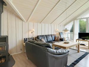 a living room with a couch and a table at 6 person holiday home in Hemmet in Falen