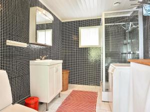 a bathroom with a toilet and a sink and a shower at Two-Bedroom Holiday home in Hallabro 3 in Hallabro