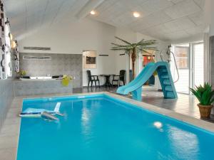 a swimming pool with a slide in a house at 22 person holiday home in Sydals in Sønderby