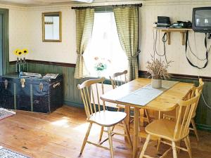 a dining room with a wooden table and chairs at 4 person holiday home in ANKARSRUM in Hult