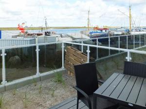 a patio with a table and chairs next to a marina at 3 person holiday home in Wendtorf in Wendtorf