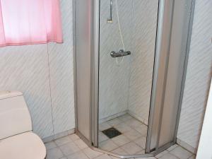 a shower with a glass door in a bathroom at Holiday Home Vågland in Vågland