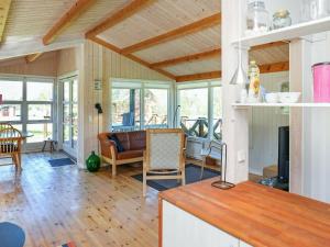 a kitchen and living room with a table and chairs at 5 person holiday home in Stege in Stege