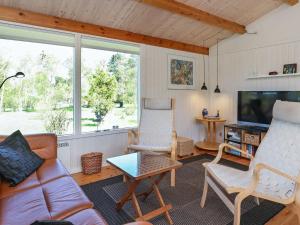 a living room with a couch and chairs and a tv at 5 person holiday home in Stege in Stege