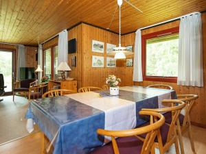 a dining room with a blue table and chairs at 6 person holiday home in R m in Bolilmark