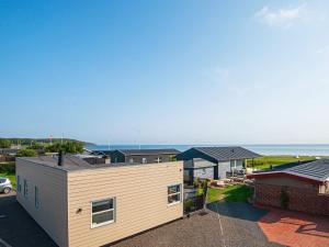 an aerial view of a house with the ocean in the background at 6 person holiday home in Juelsminde in Sønderby