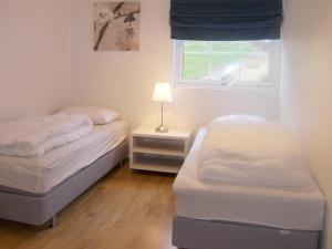 2 camas en una habitación pequeña con ventana en Two-Bedroom Holiday home in Leikanger, en Leikanger