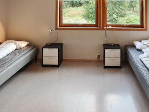 a room with two beds and two night stands at 12 person holiday home in Oksvoll in Oksvoll +48 photos